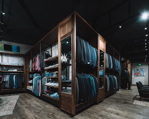 Multiple clothing racks of high-end men's apparel